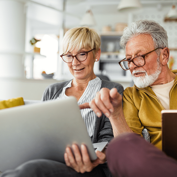 elderly-couple-on-computer-in-couch