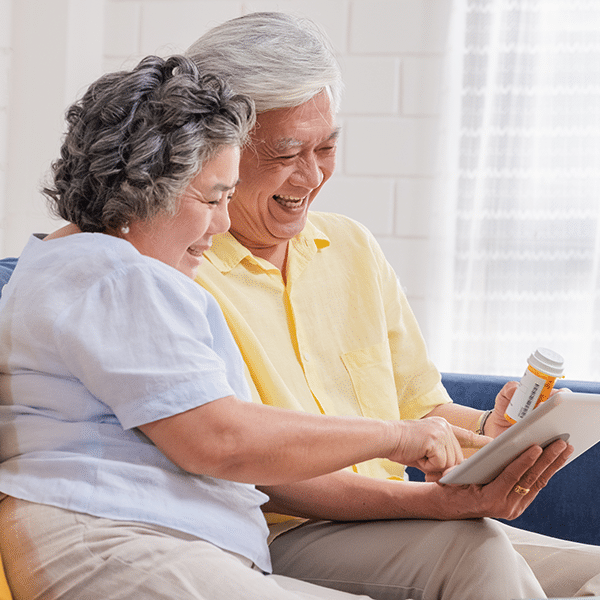 elderly-couple-on-tablet-couch